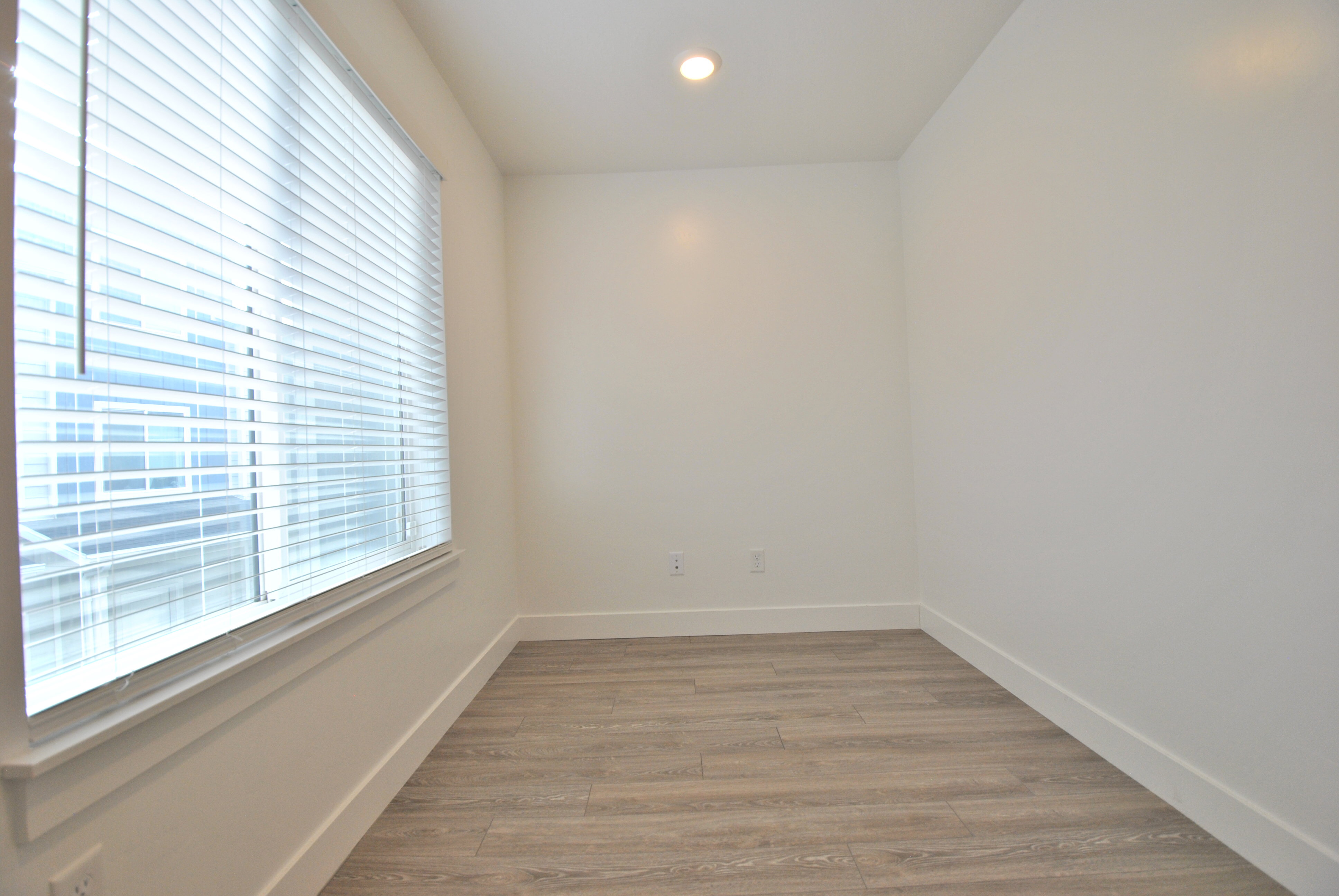 Office nook featuring light wood finished floors and recessed lighting