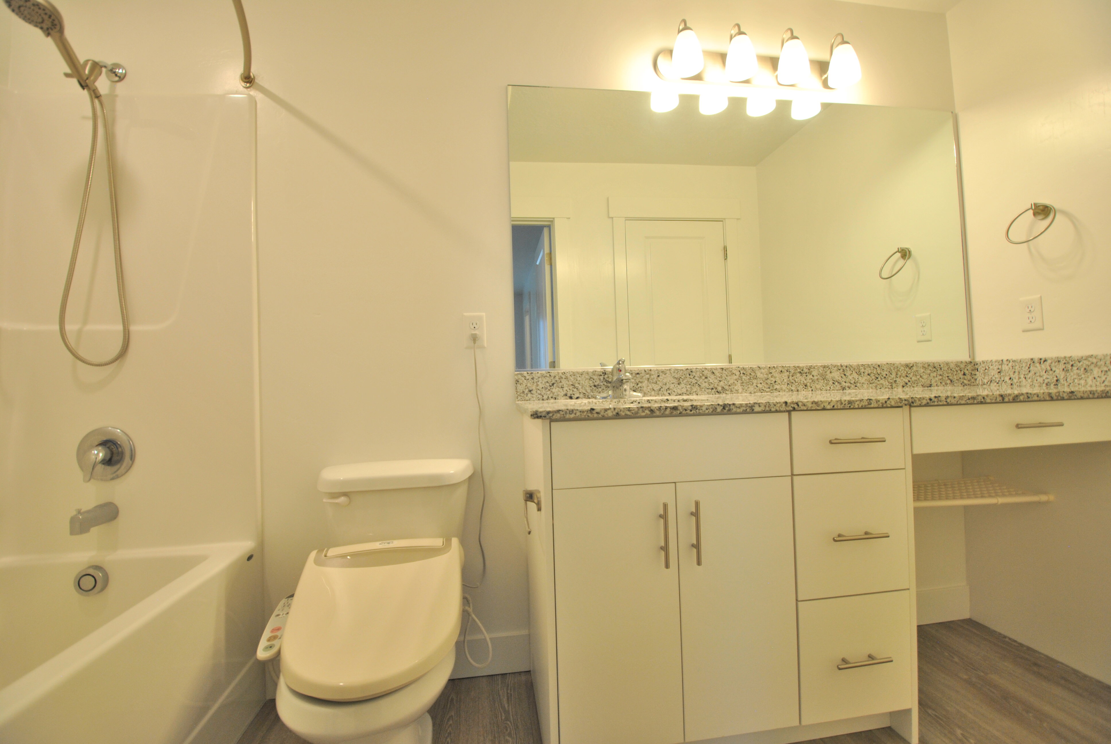 Primary full bath featuring vanity, shower / washtub combination, and dark wood-type flooring