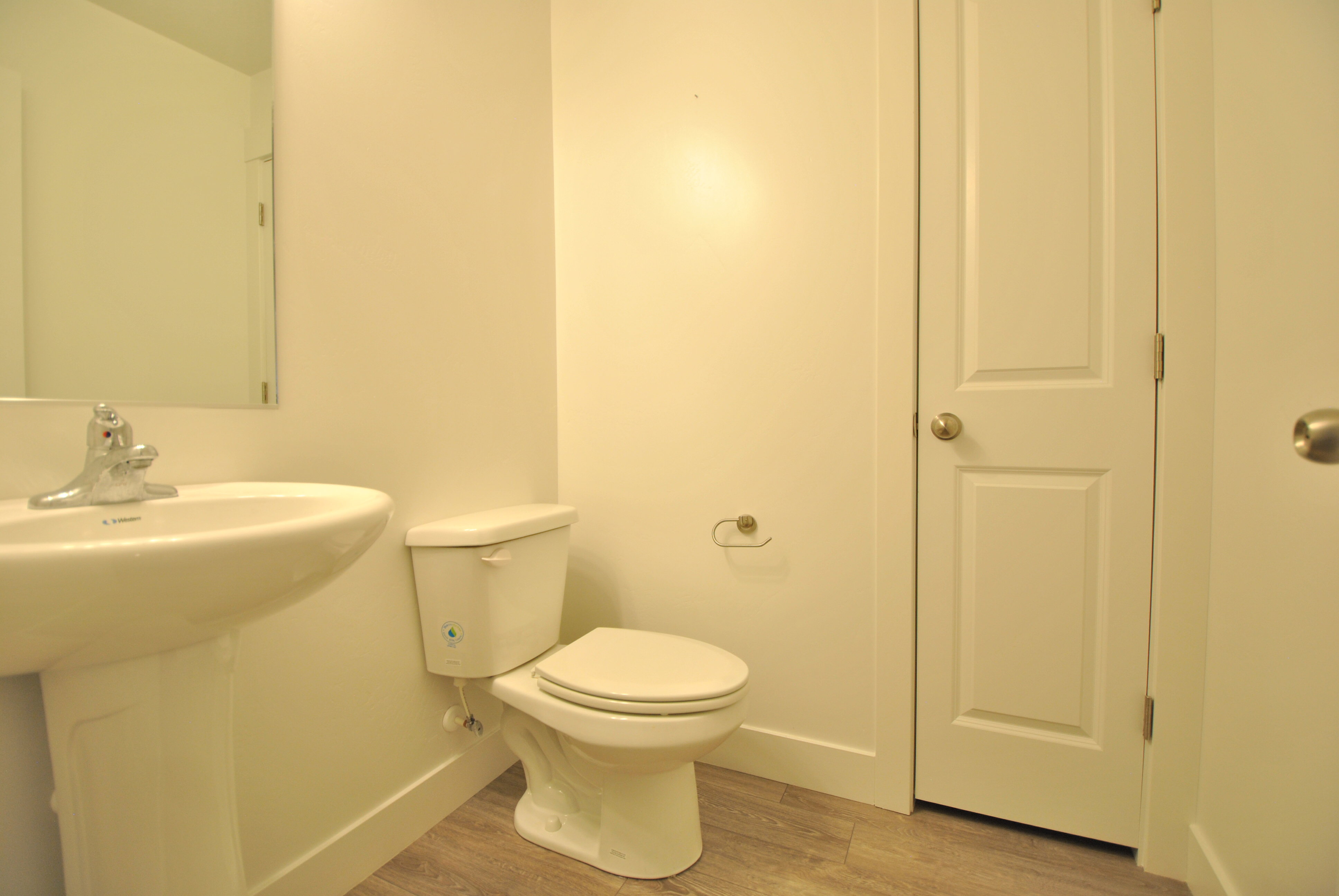 Half Bathroom featuring toilet and light wood-style flooring