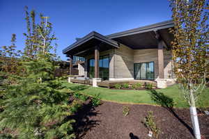 Back of property with a lawn and a wooden deck