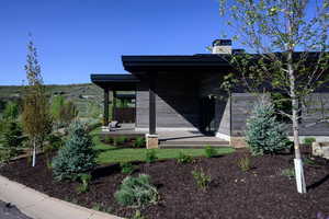 Entrance to property with a chimney and a wooden deck