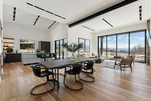 Dining space featuring light wood finished floors, a mountain view, and beam ceiling