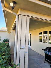 View of patio with a grill
