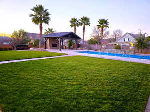 Yard at dusk featuring a patio area and a fenced backyard