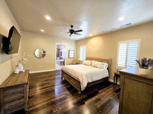 Bedroom with recessed lighting, dark wood-style flooring, ensuite bath, and ceiling fan
