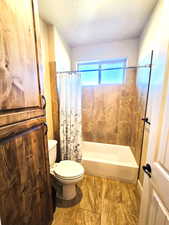 Bathroom with shower / bath combo and toilet