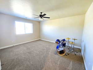 Rec room with carpet floors and ceiling fan