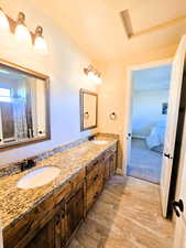 Full bath featuring double vanity and curtained shower