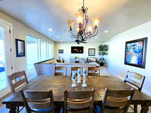 Dining room with a chandelier and a fireplace