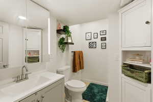 Half bath with vanity and a textured ceiling