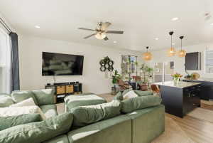 Living room featuring a ceiling fan, light wood finished floors, and recessed lighting