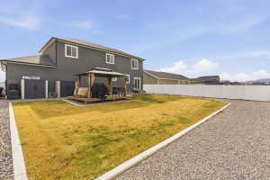 Back of property featuring a gazebo, a wooden deck, a fenced backyard, and a shingled roof