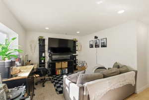 Living room with a desk and recessed lighting