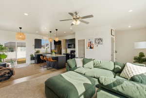 Living room with light wood-type flooring, recessed lighting, and ceiling fan