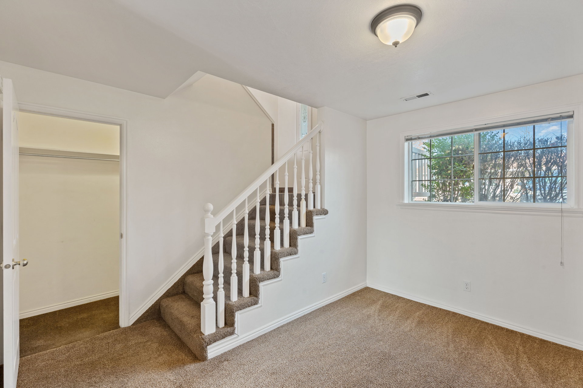 Stairway with carpet floors, large Storage available underneath stair risers.