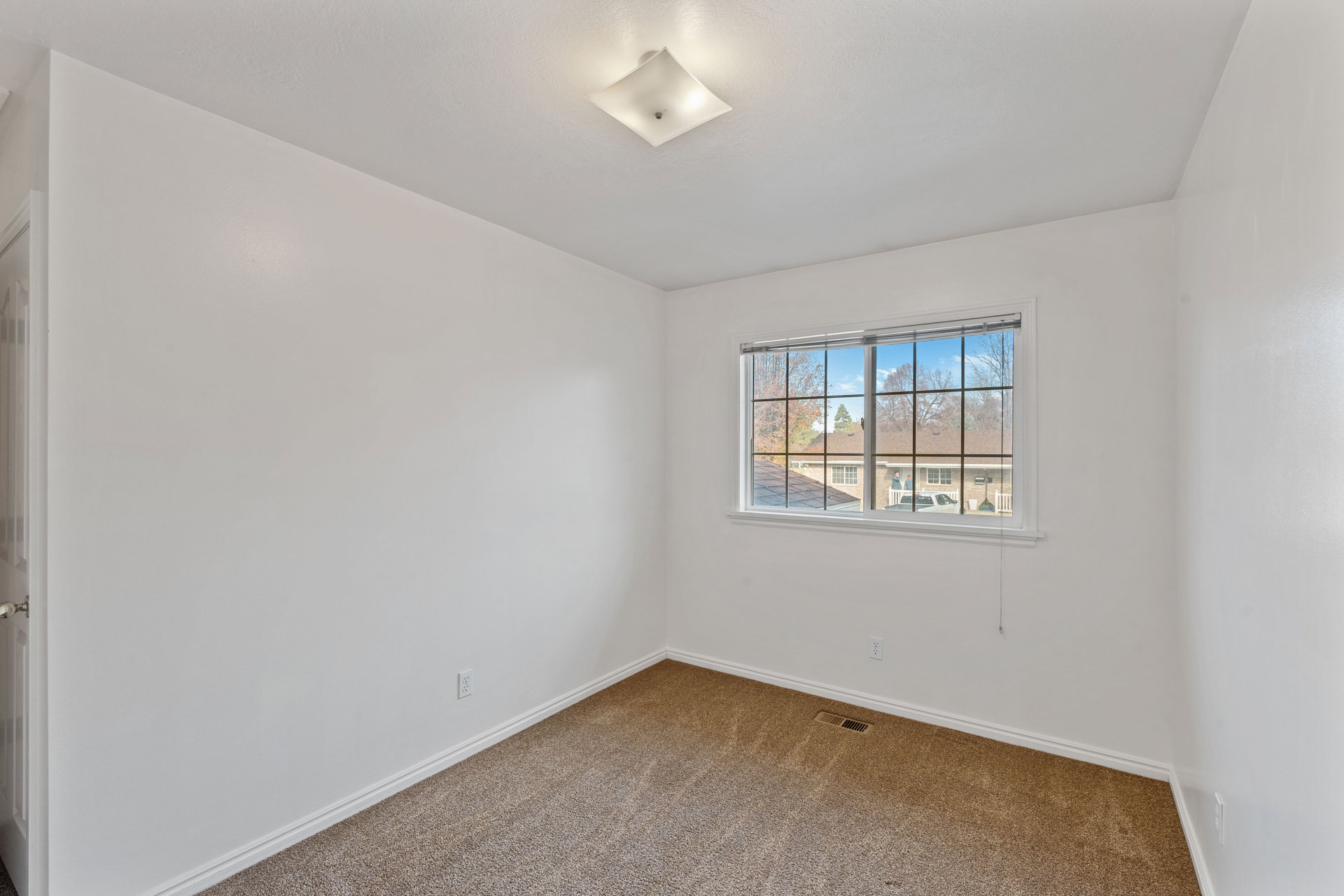 Unfurnished room featuring carpet floors and baseboards