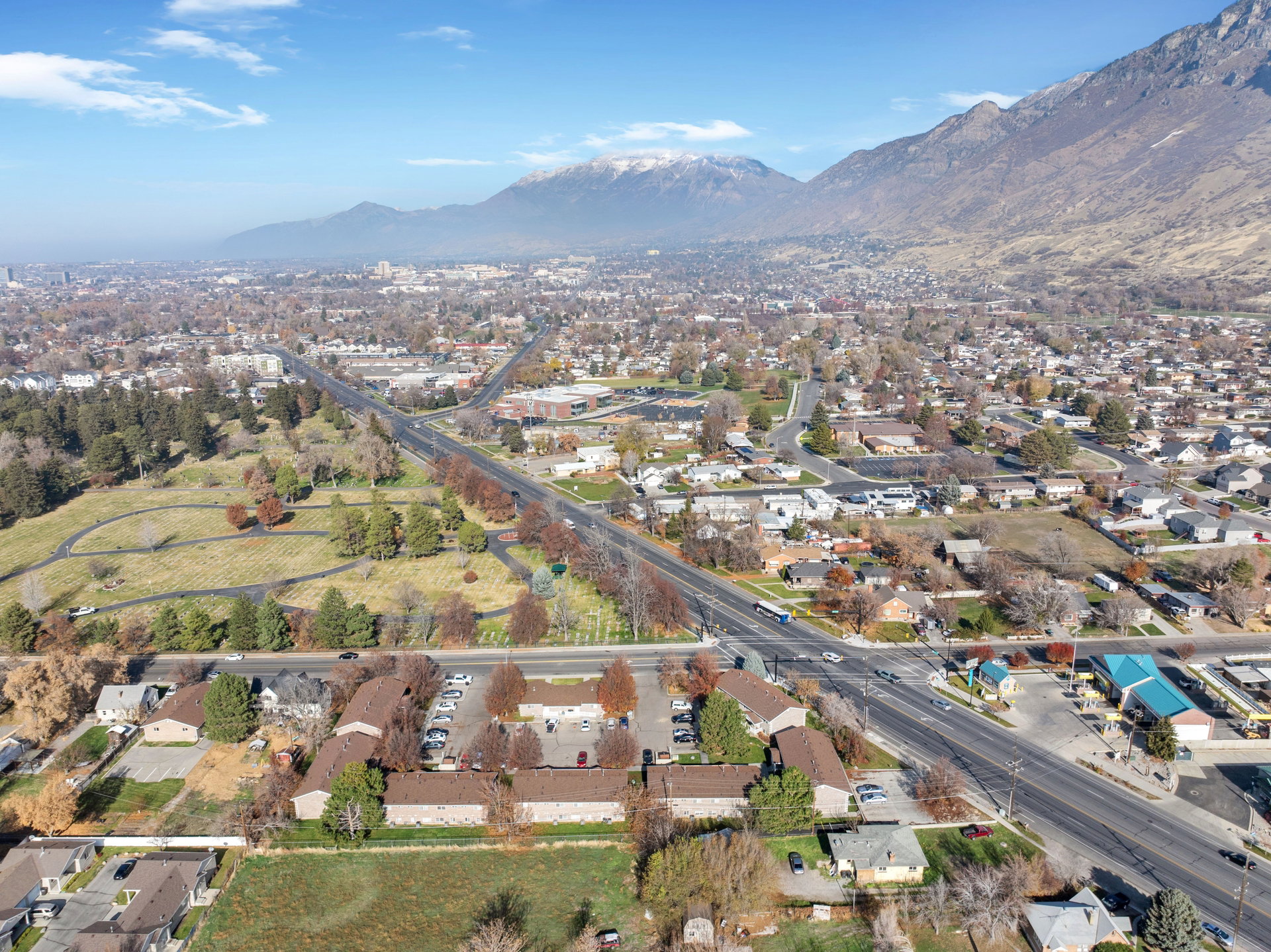 Aerial overview of property's location featuring nearby suburban area and a mountainous background