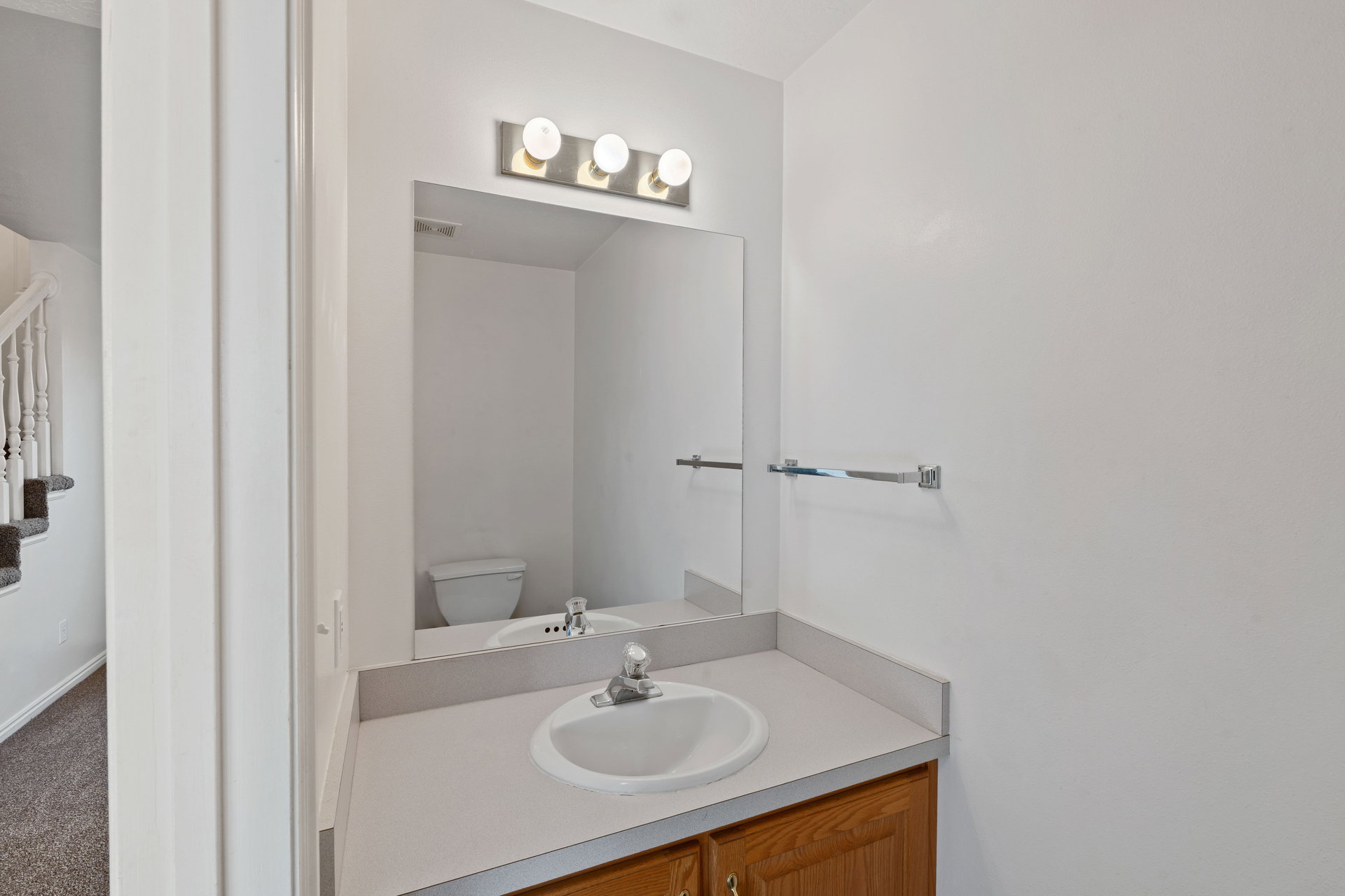 Half bathroom with vanity and toilet