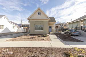 View of front of home featuring brick siding and a gate