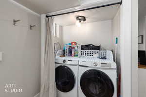 Laundry room with washing machine and clothes dryer