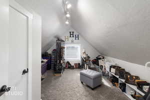 Interior space with a textured ceiling and carpet floors