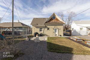 Back of property featuring a patio area, a fenced backyard, brick siding, a garden, and a shingled roof