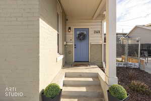 Doorway to property with brick siding