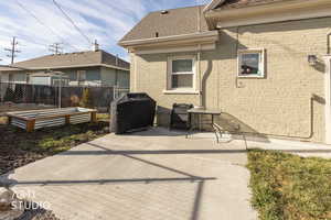 View of patio with a grill