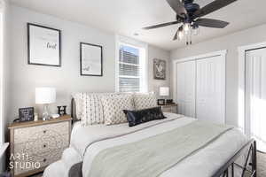 Carpeted bedroom featuring a closet and ceiling fan