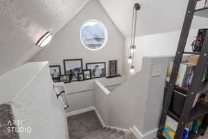 Stairs with a textured wall and carpet