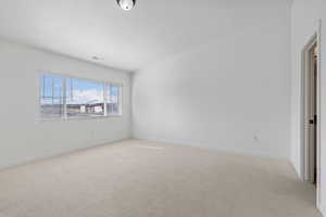 Unfurnished room featuring light carpet and a textured ceiling