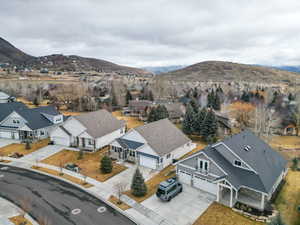 Aerial perspective of suburban area featuring a mountainous background