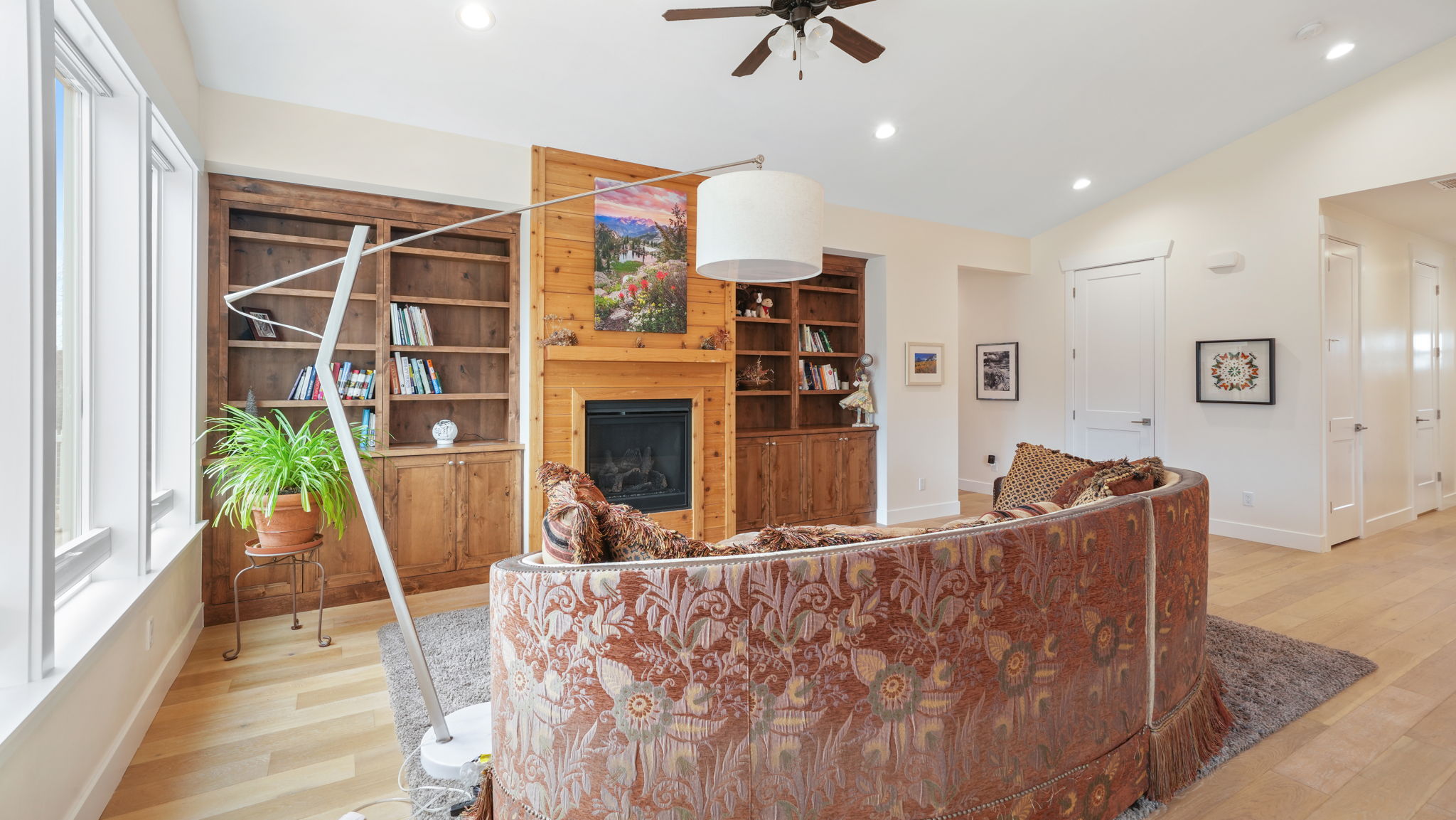 Living area featuring wood-finish flooring, recessed lighting, and a ceiling fan