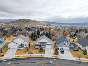 Aerial perspective of suburban area with a mountainous background