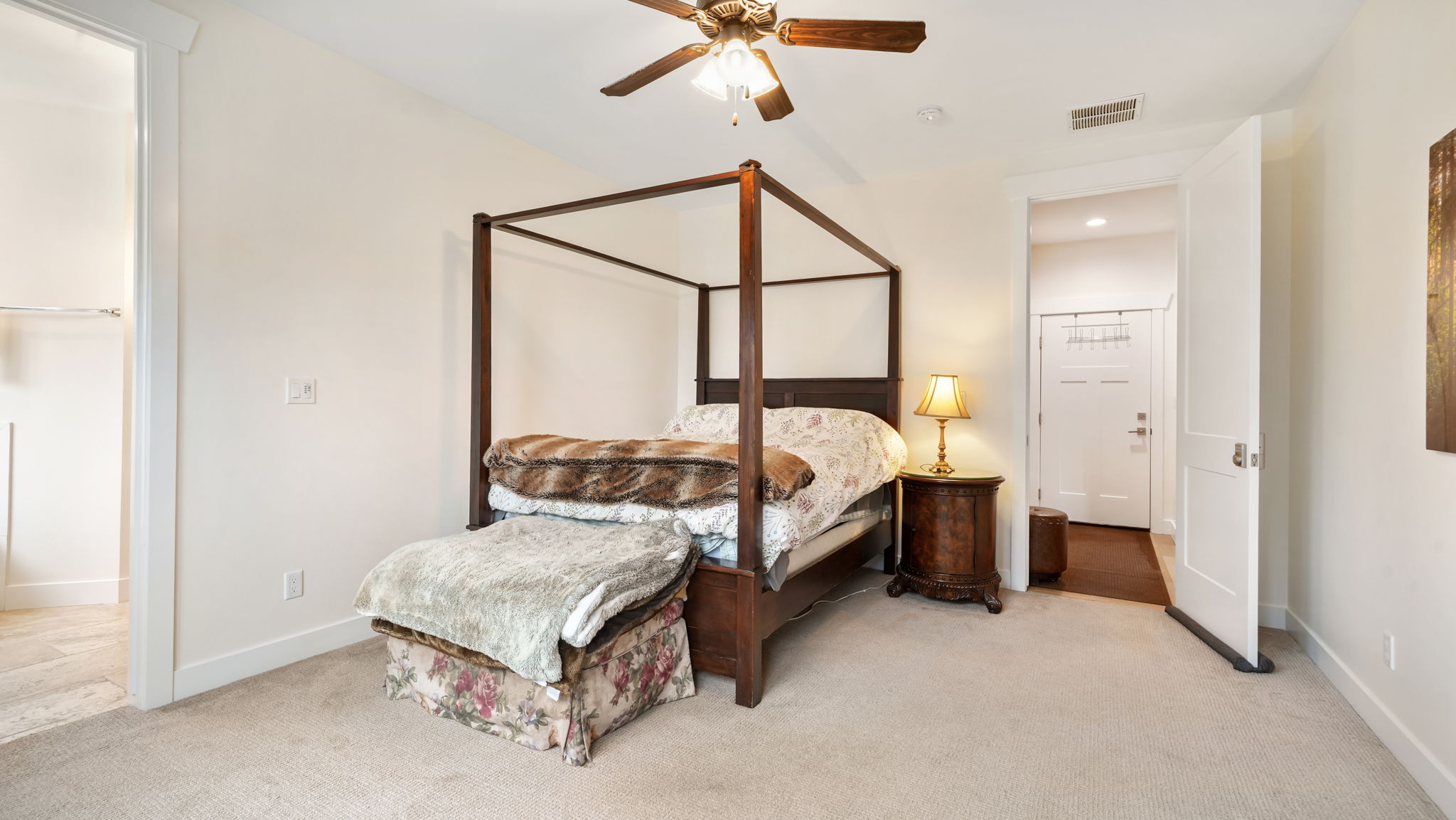 Bedroom featuring light-colored carpeting, a ceiling fan with integrated lighting, and white trim