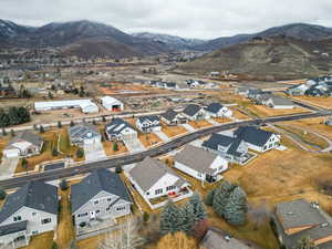 Aerial overview of property's location featuring nearby suburban area and mountains