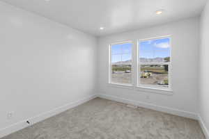 Unfurnished room with a mountain view, light carpet, and recessed lighting