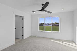 Unfurnished room with light colored carpet, a ceiling fan, and recessed lighting