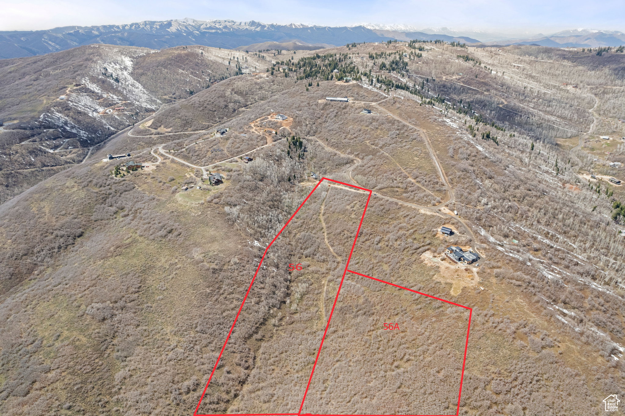 Aerial view of property's location featuring a mountain backdrop and property parcel outlined