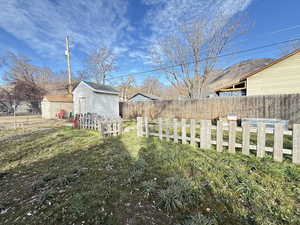 Fenced backyard with a storage shed.