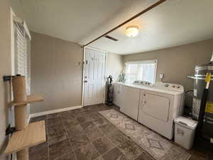 Laundry area with INCLUDED washer and dryer, water heater and door to backyard.
