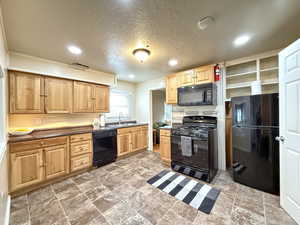 Kitchen with light wood finish cabinetry and included appliances!