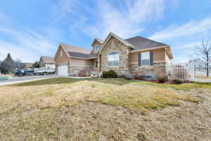 Craftsman-style house featuring stone siding, stucco siding\