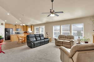 Living area with lofted ceiling, and ceiling fan
