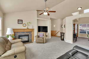 Living room,, a fireplace, vaulted ceiling, and arched walkways