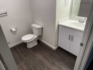 Bathroom featuring vanity and dark wood finished floors