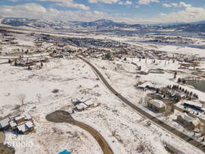 Snowy aerial view with a mountain view and a residential view