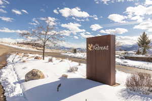 Yard covered in snow with a mountain view