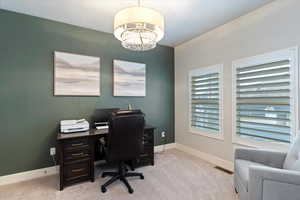 Office area featuring light carpet and suspended lighting