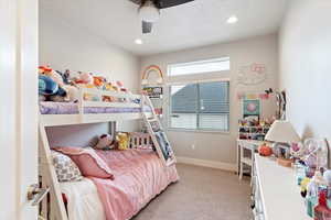 Bedroom featuring light carpet, a textured ceiling, recessed lighting, and ceiling fan